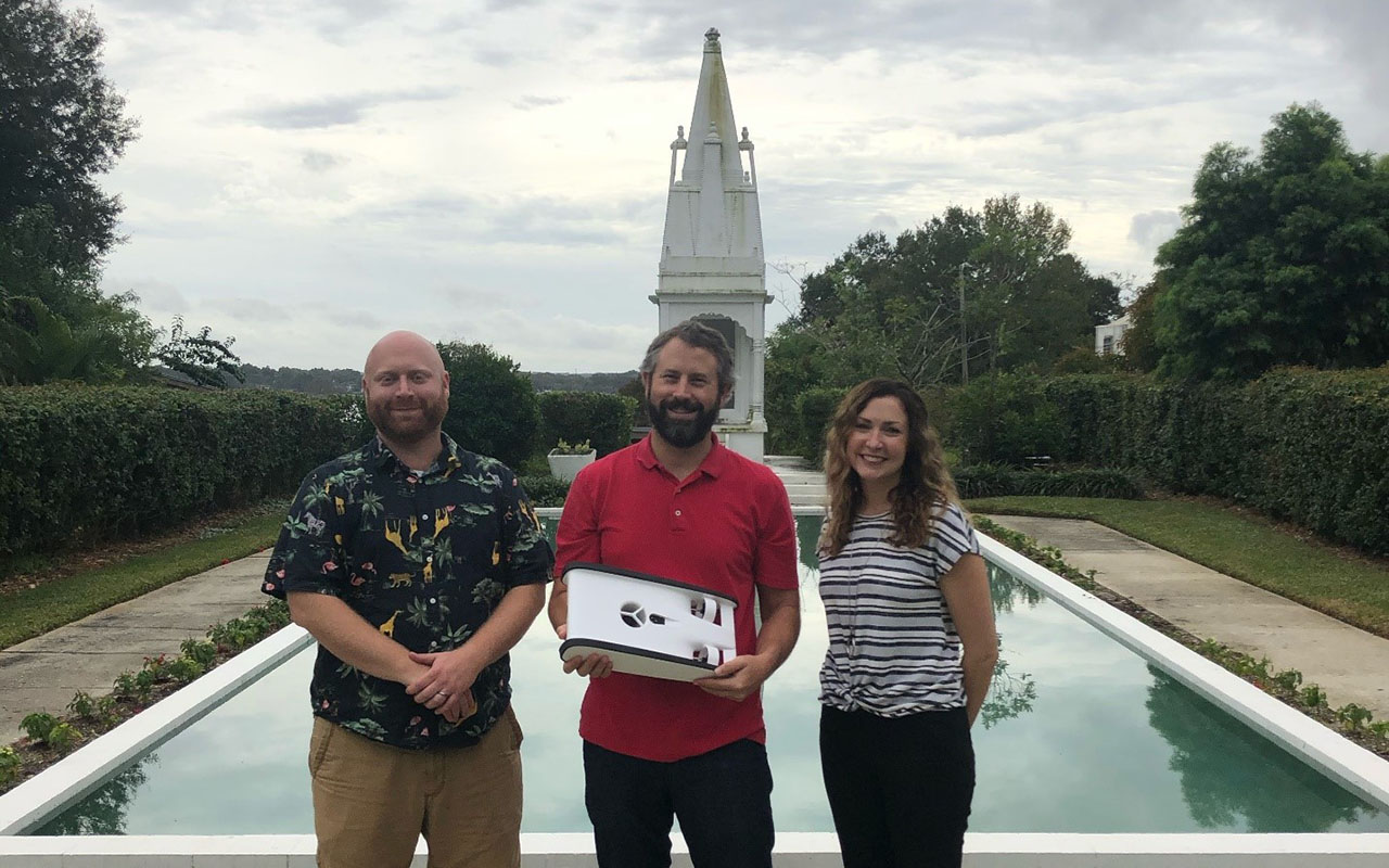 (From left to right) Drs. Jason Macrander, Gabe Langford and Melanie Langford show off the new Trident ROV in the Hindu Garden on the FSC campus.