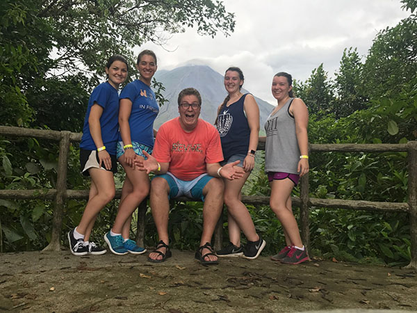 Trip director Mr. Manning and the students near the volcano at La Fortuna.