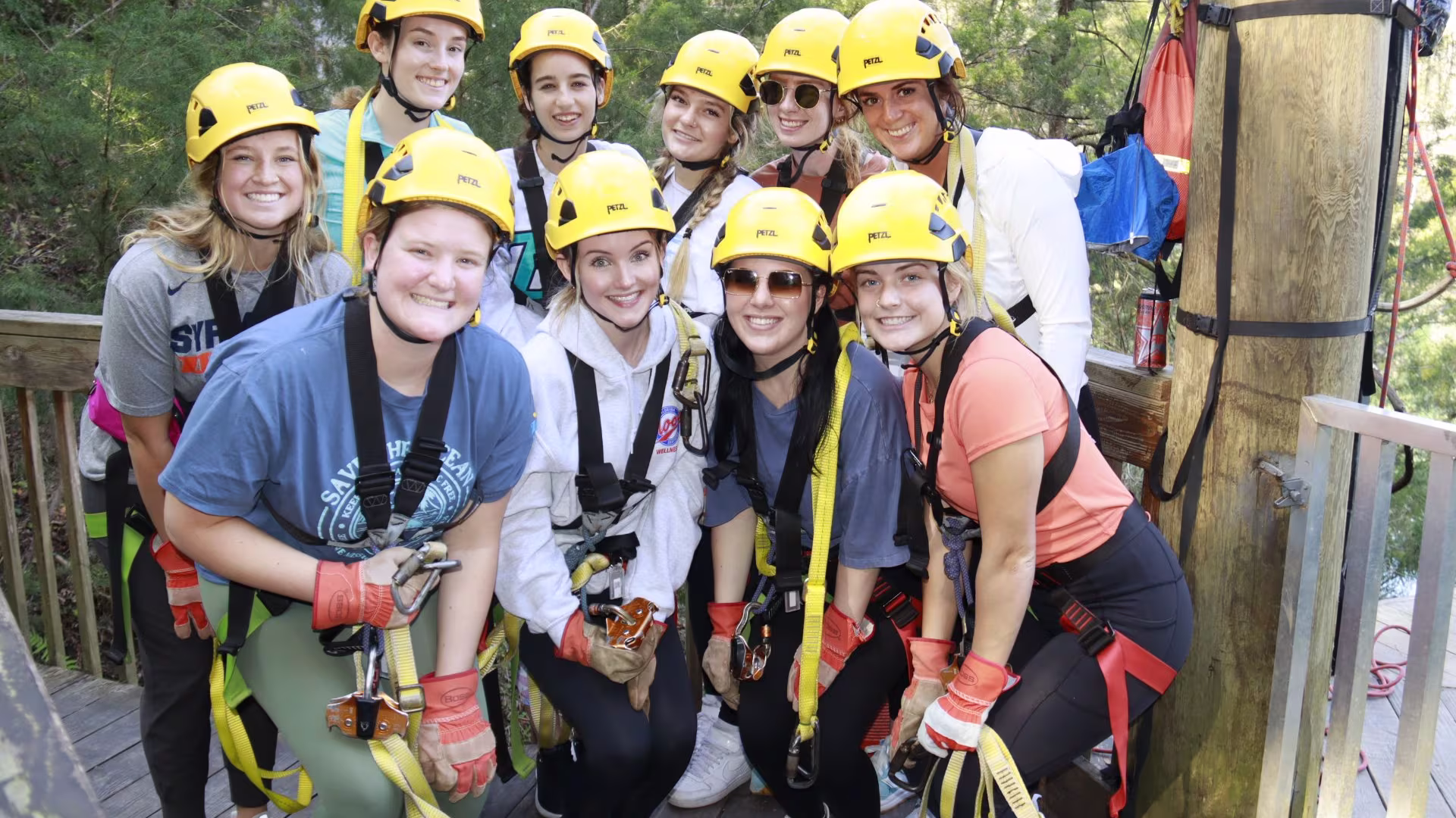 students wearing climbing harnesses and helmets 