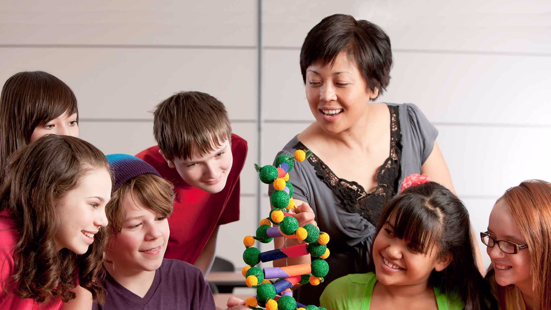 Students building model with teacher