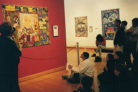 students sitting in a museum looking at art