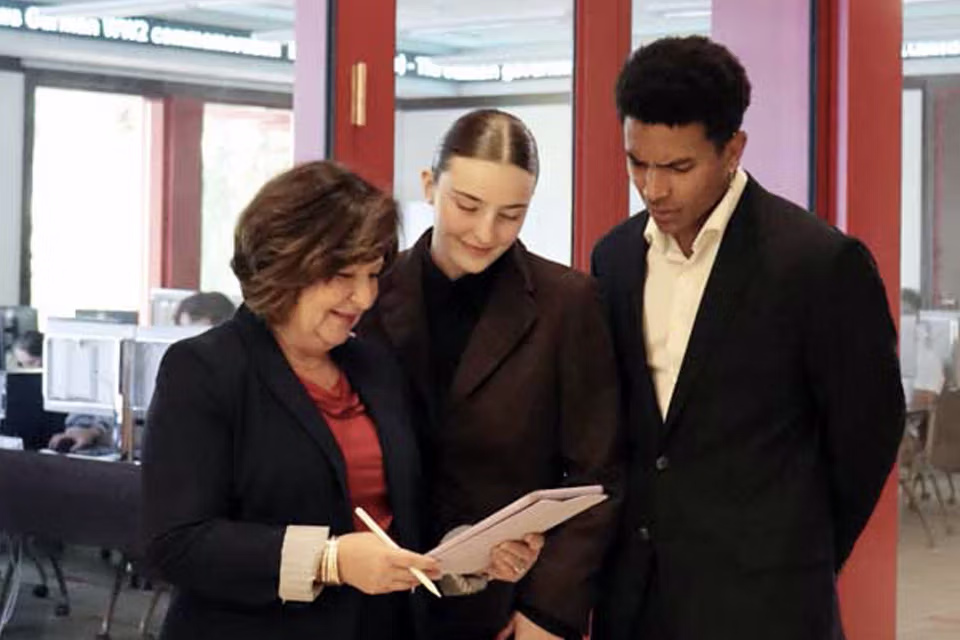 a professor working with two students