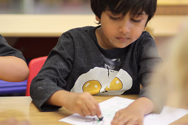 A student practicing writing