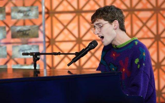 Zachary playing piano on stage
