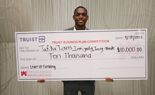Happyson Kaunda with his prize check