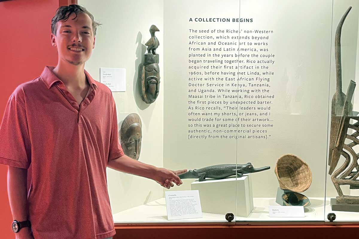 Brown in front of an alligator carving