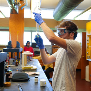 Jason Rowe holding lab equipment