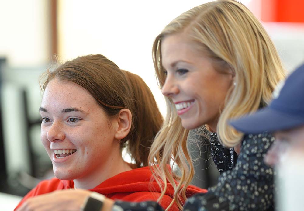 smiling teacher helping student