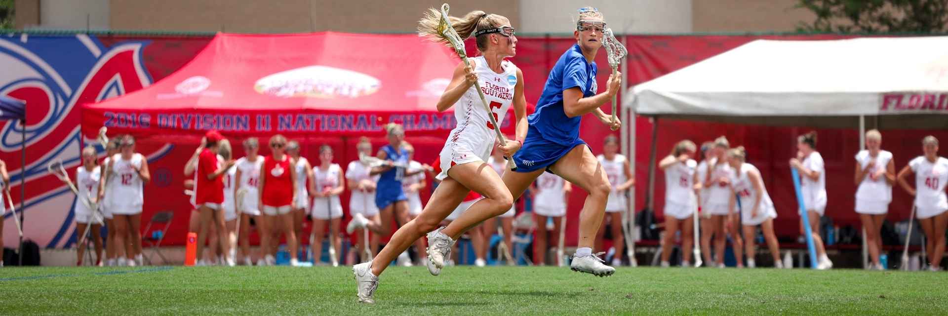 two female players playing lacrosse
