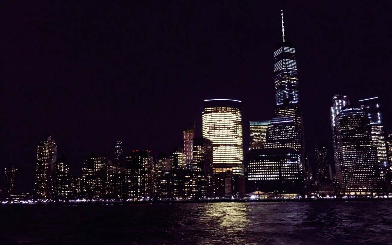 View of New York City at night from a water taxi.