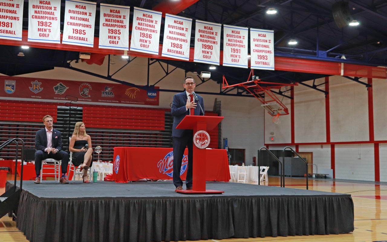 drew howard on stage giving a speech