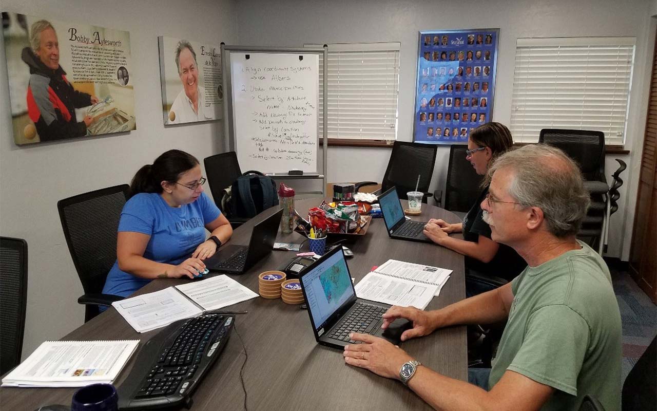 From left to right: Professor Daugherty, Dr. Wolovich and Dr. Kjellmark exploring the uses of GIS technology at the Sea Grant UF training program.