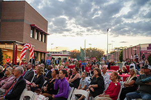 Crowd listening to speakers at The Roberts Academy dedication ceremony.