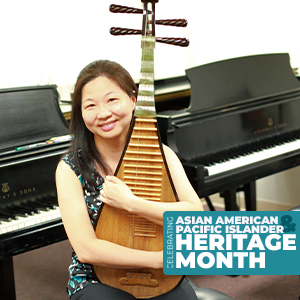Dr. Fen-Fang Chen with a pipa, a traditional Chinese instrument