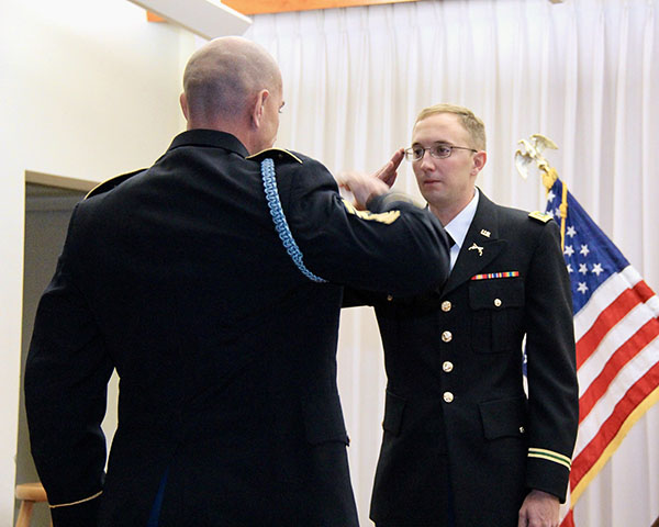 Captain Cody Khork saluting an officer