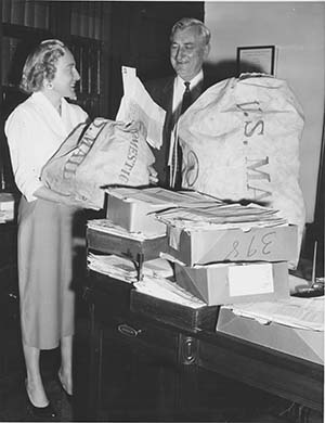 James Haley and Alice Myers holding large mail bags