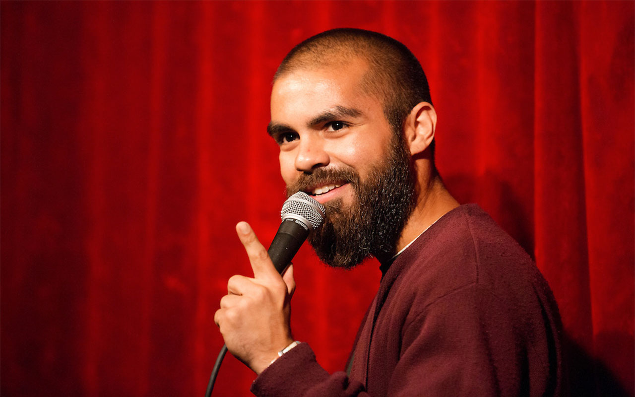Rojo Perez '07 performing at a comedy show.