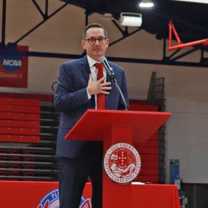 drew howard on stage giving a speech