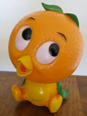 The front of an Orange Bird coin bank