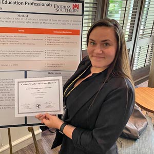 clair harris with award certificate