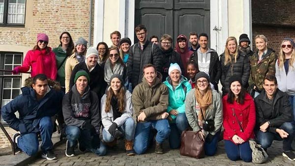 students kneeling for a photo in the netherlands