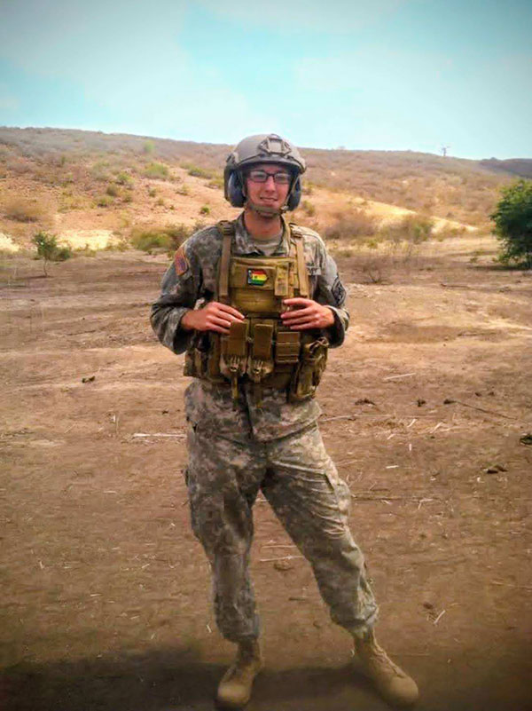 Captain Cody Khork wearing tactical gear in a desert environment