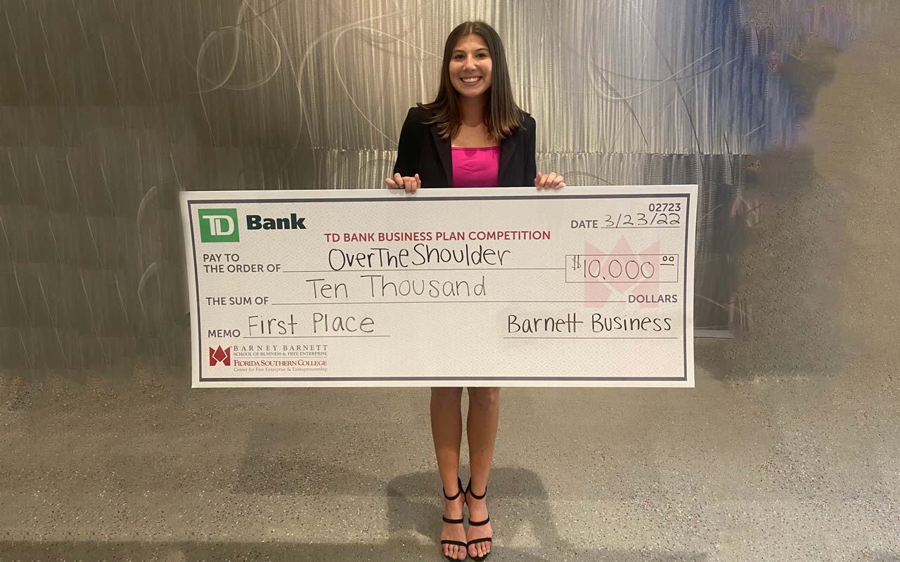 Brooke Lierman holding a big check