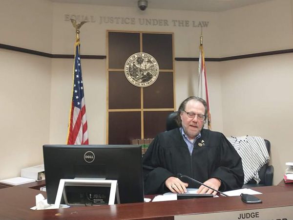 Judge Steve Jewett at a desk