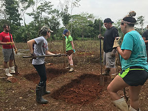 The students are starting to dig the well for a local family.