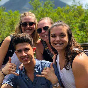 Jessie '20 (front right) at the top of a mountain overlooking the beautiful Volcano with three other students.