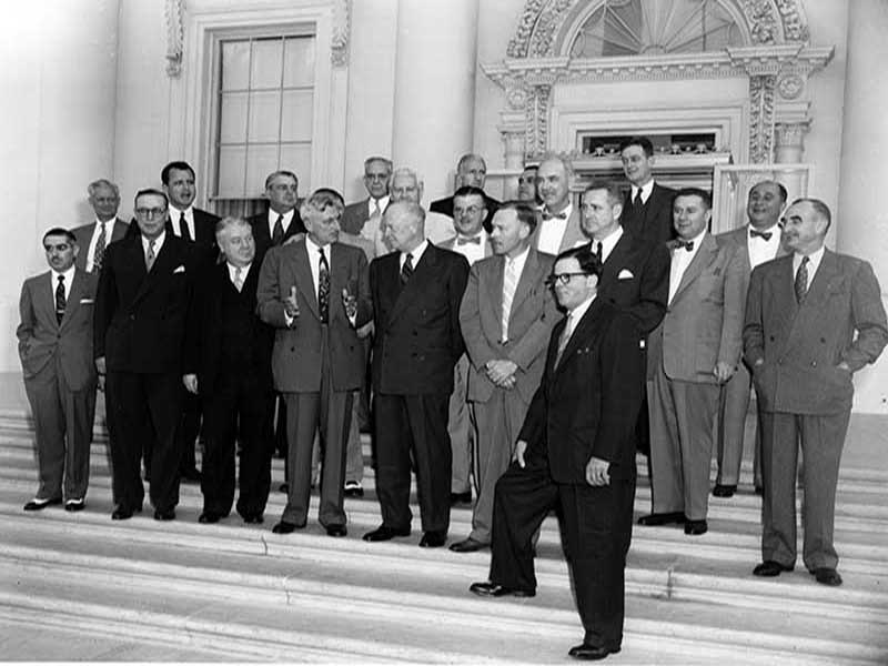 James Haley speaking with president Eisenhower among a group of people posing for a photo on the steps of the White House