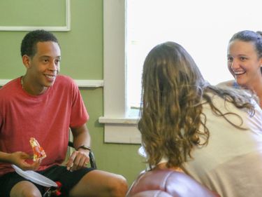 Students socializing and eating pizza